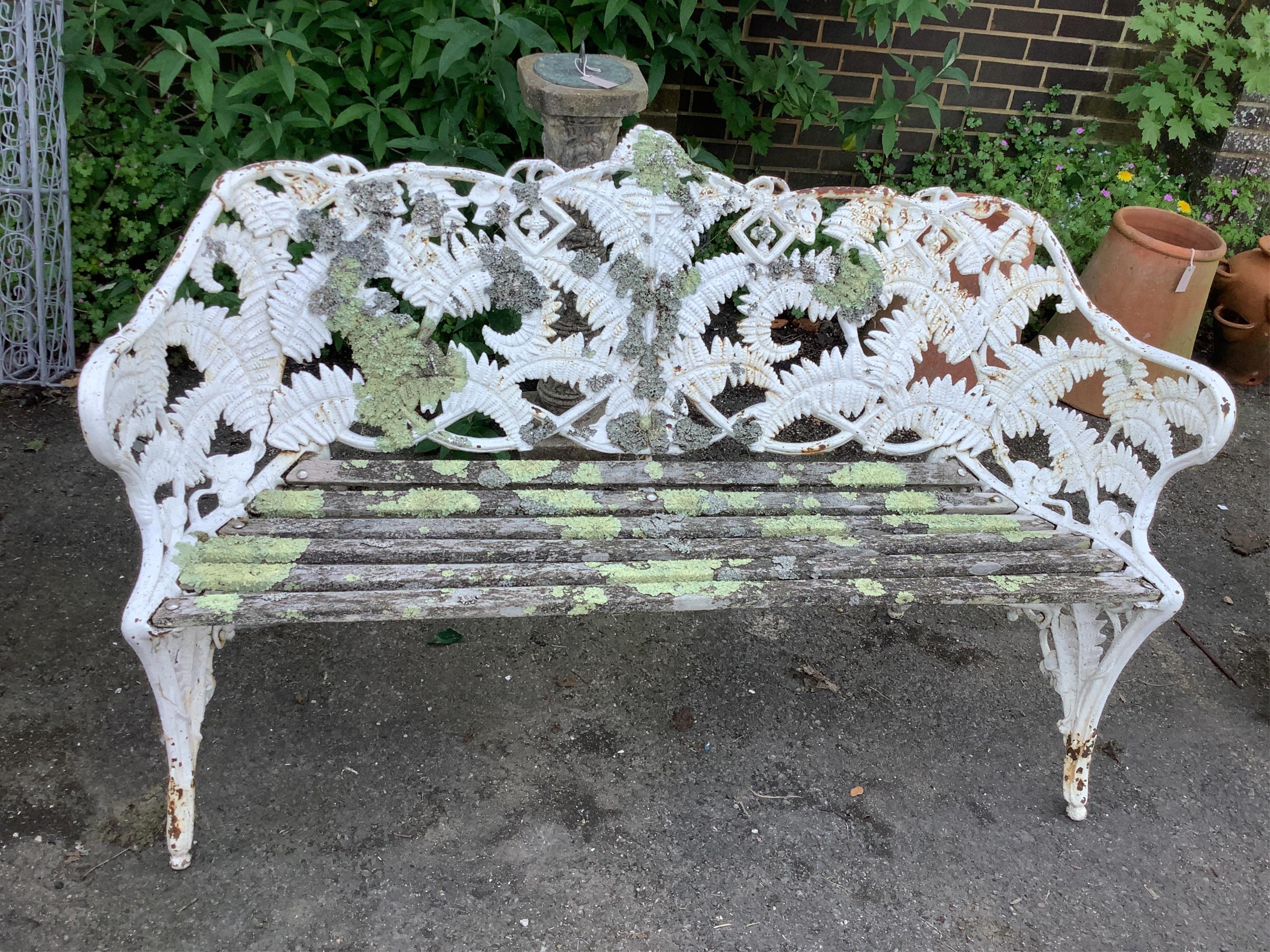 A Victorian Coalbrookdale style fern pattern white painted cast iron garden bench, width 152cm, depth 56cm, height 91cm